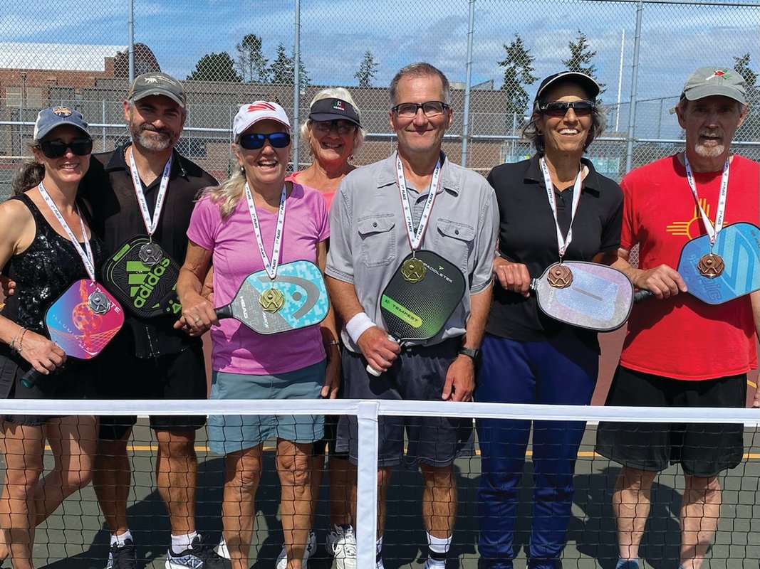Inaugural pickleball tournament medalists Erica and Brandon Mack, Mary Critchlow and Bill Dennis, Toni Davison and Rick Kelley, and events director/tournament organizer Jeannie Ramsey (behind) pose following the event.